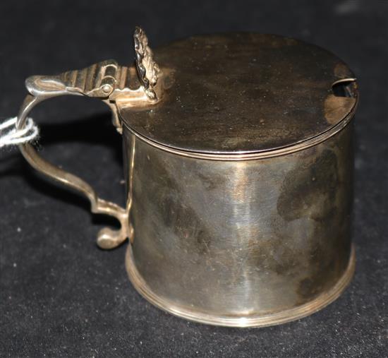 A George III silver drum mustard, of plain form with anthemion thumbpiece and blue glass liner, London 1797, maker Thomas Meriton